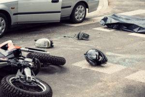 A motorcycle helmet lies next to the scene of an accident.