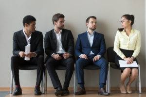 diverse male applicants looking at female rival