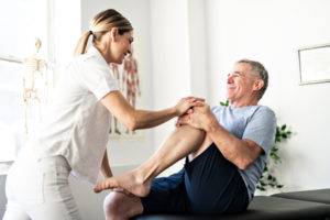 older man receiving physical therapy