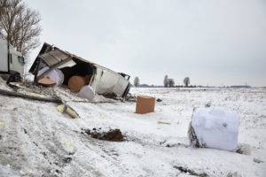 overturned cargo truck in the snow