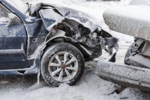 two cars in an accident in the snow
