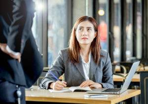 angry manager reprimands an office worker