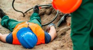 injured construction worker lying in a ditch