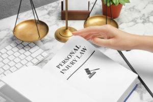 personal injury law book with scales of justice
