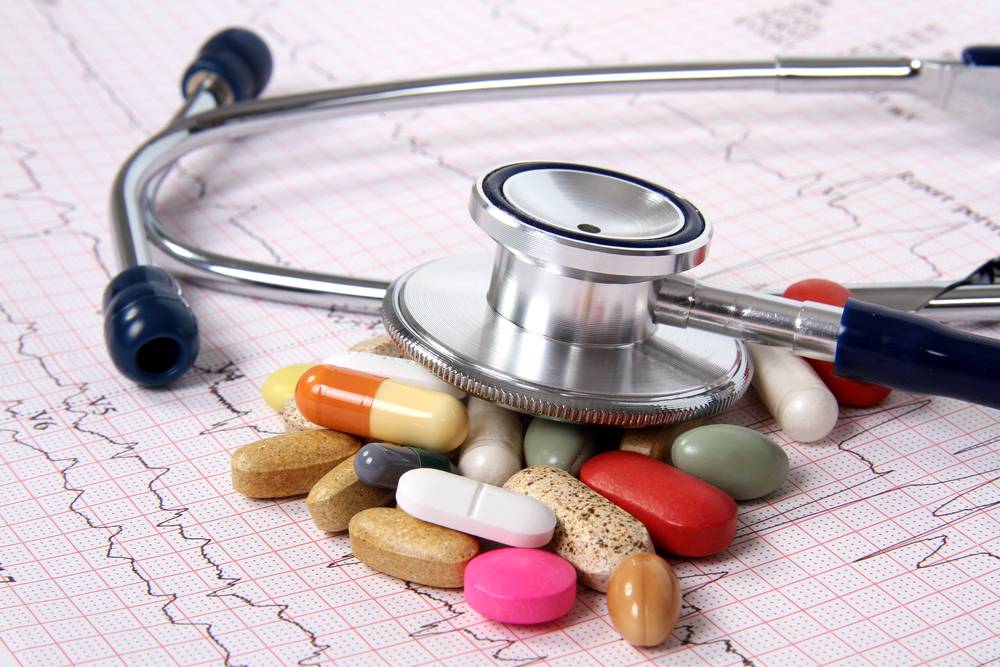 spilled medication and stethoscope on cardiogram