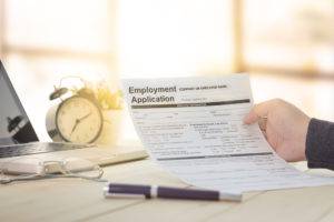 businessperson holding up employee application