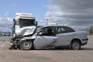 a large truck and a car after a collision