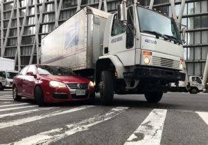 a large truck turning across the path of a passenger vehicle