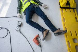 electrocuted construction worker on ground next to gurney