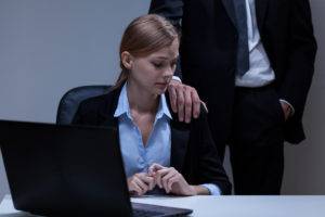 woman at work looking uncomfortable at being touched