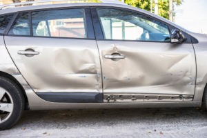 car door smashed after a hit-and-run accident