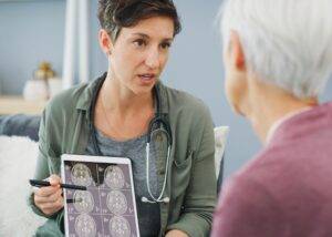 Doctor shows test results to patient with a diffuse axonal injury (DAI)