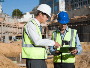 Construction workers reviewing paperwork